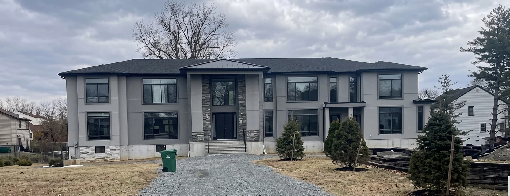 Front elevation of the Paramus luxury residence with stone entry pillars
